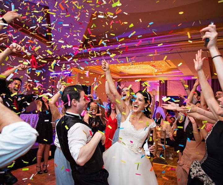 A packed dance floor under confetti late in the night